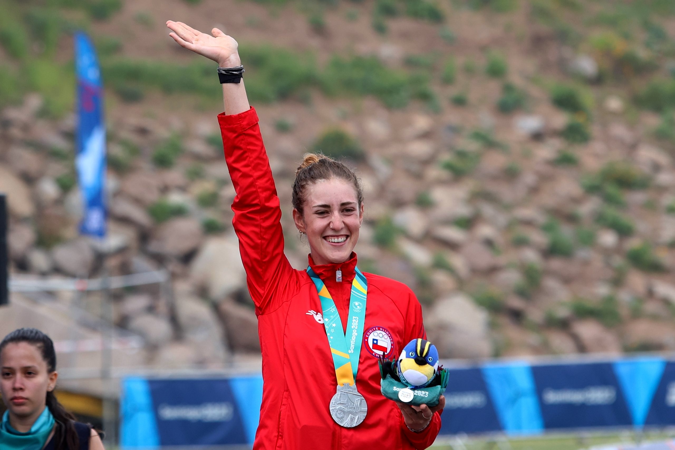 Catalina Vidaurre waving from the podium with her silver medal at the Santiago 2023 Pan American Games